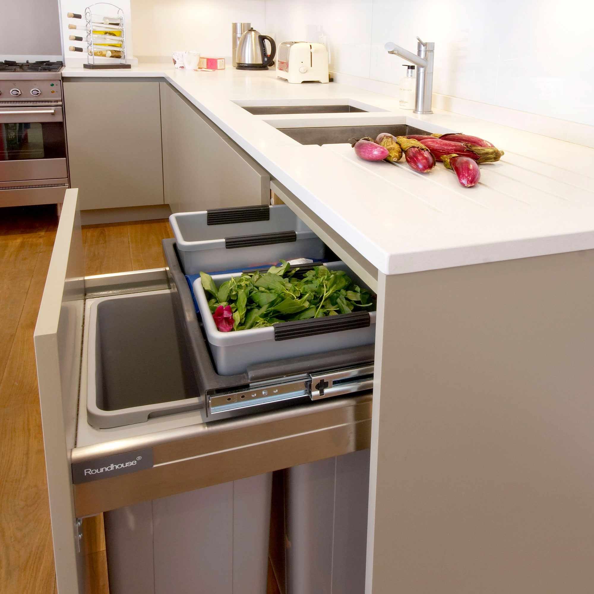 Pull-out kitchen drawer containing separate recycling bins.